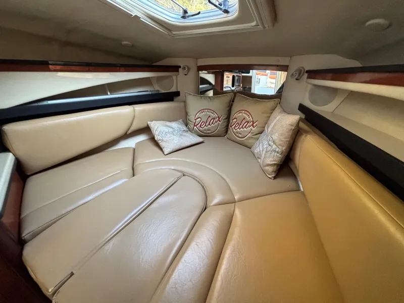 Slide: The Image of Luxurious interior of 2005 Sea Ray 260 Sundancer with plush seating and decorative pillows. - 24