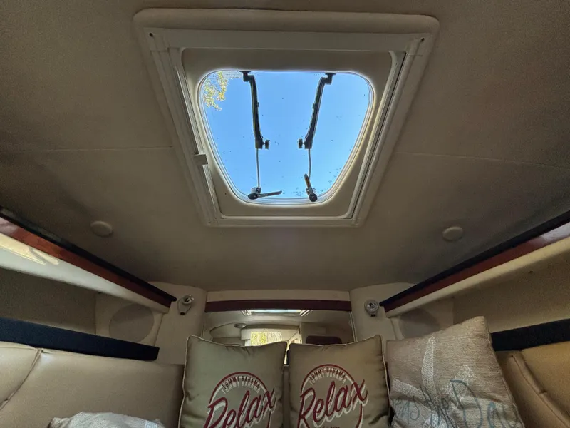 Slide: The Image of Interior cabin view of 2005 Sea Ray 260 Sundancer with skylight and cozy pillows. - 26