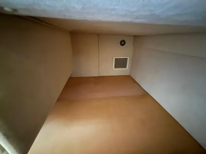 Slide: The Image of Interior cabin space of 2005 Sea Ray 260 Sundancer boat, featuring beige walls and vent. - 36
