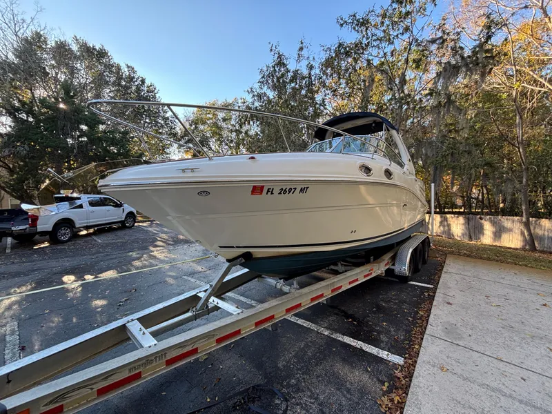 Slide: The Image of 2005 Sea Ray 260 Sundancer boat on trailer in parking lot. - 7