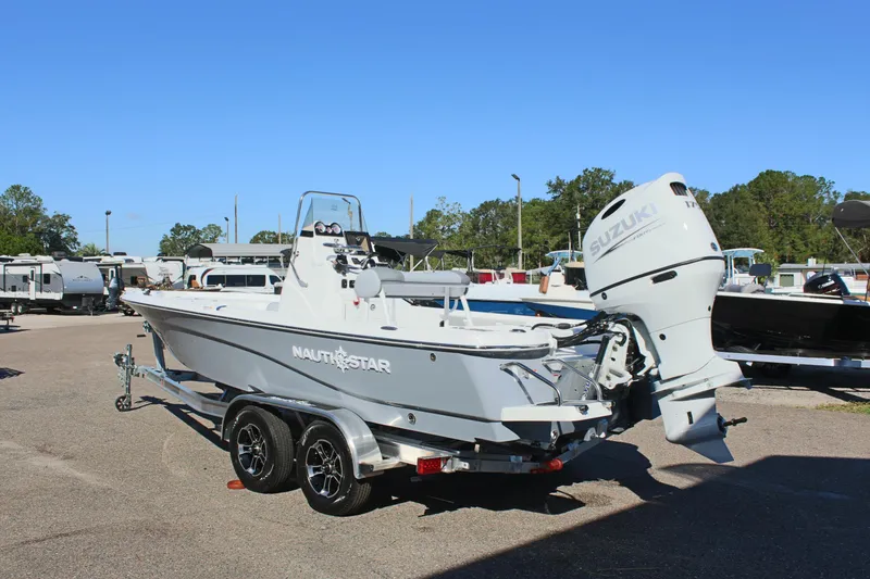 Slide: The Image of 2025 NauticStar 214 Shallow Bay boat on trailer with Suzuki outboard motor. - 10