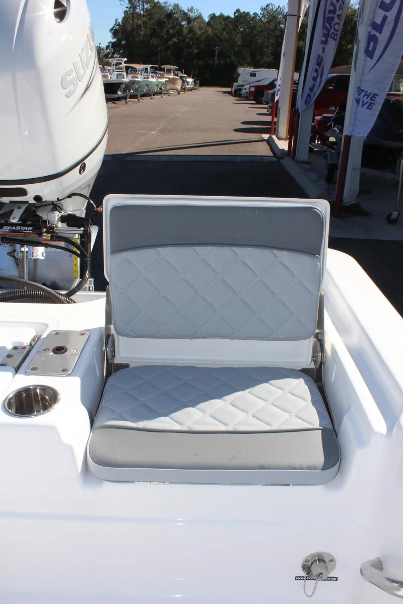 Slide: The Image of 2025 NauticStar 214 Shallow Bay boat seat with quilted design and motor in background. - 13