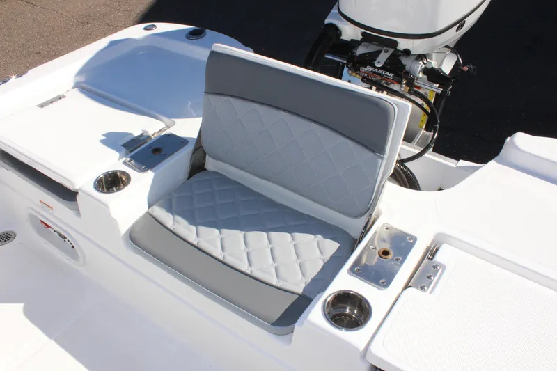 Slide: The Image of 2025 NauticStar 214 Shallow Bay boat seat with quilted design and cup holders. - 14