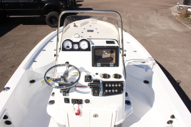 Slide: The Image of 2025 NauticStar 214 Shallow Bay boat dashboard with steering wheel and gauges. - 16