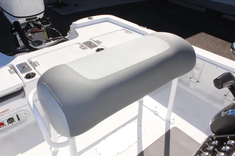 Slide: The Image of 2025 NauticStar 214 Shallow Bay boat interior with cushioned seating and control panel. - 17