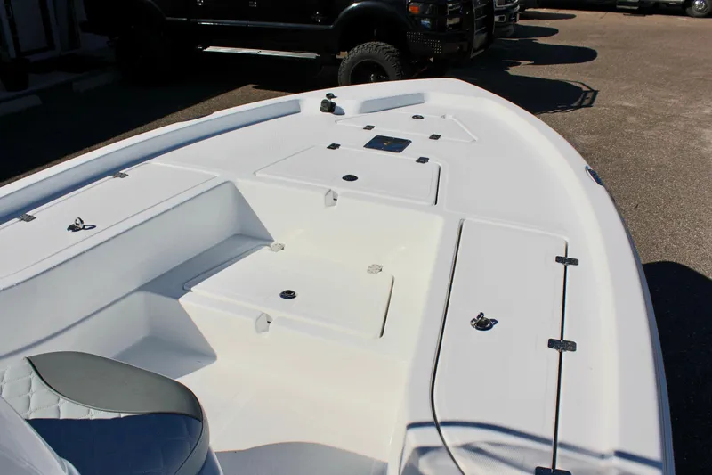 Slide: The Image of 2025 NauticStar 214 Shallow Bay boat interior with storage compartments and seating. - 20