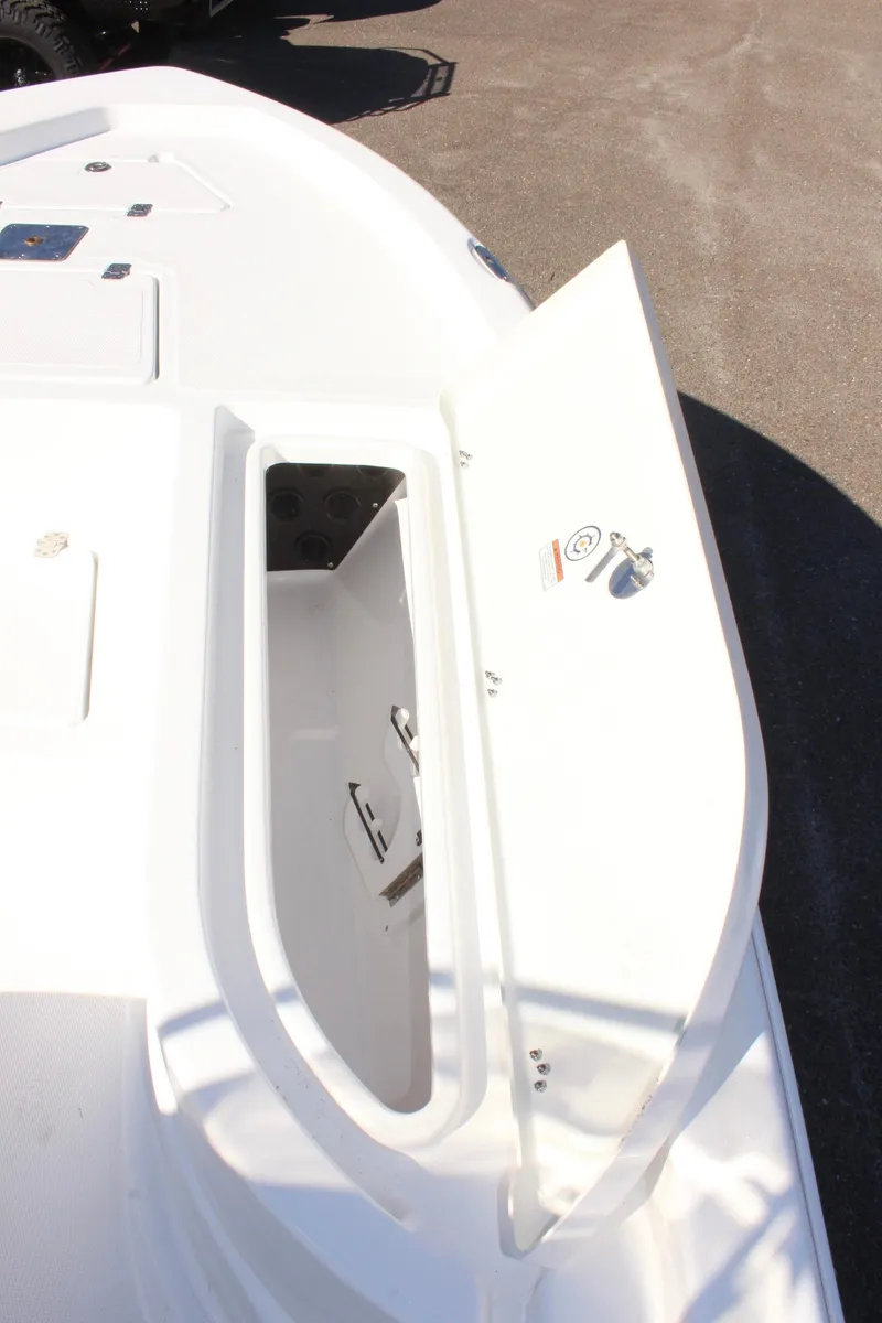 Slide: The Image of 2025 NauticStar 214 Shallow Bay boat deck with open storage compartment. - 21
