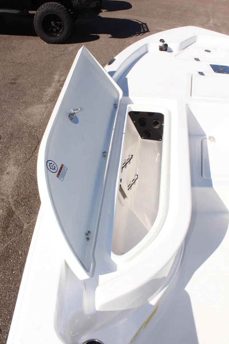 Slide: The Image of 2025 NauticStar 214 Shallow Bay boat storage compartment open on deck. - 22