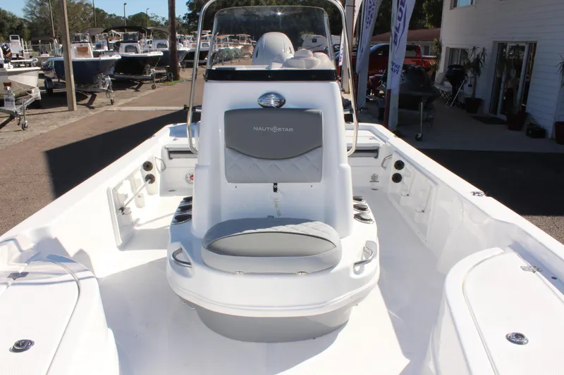 Slide: The Image of 2025 NauticStar 214 Shallow Bay boat interior with seating and console. - 26