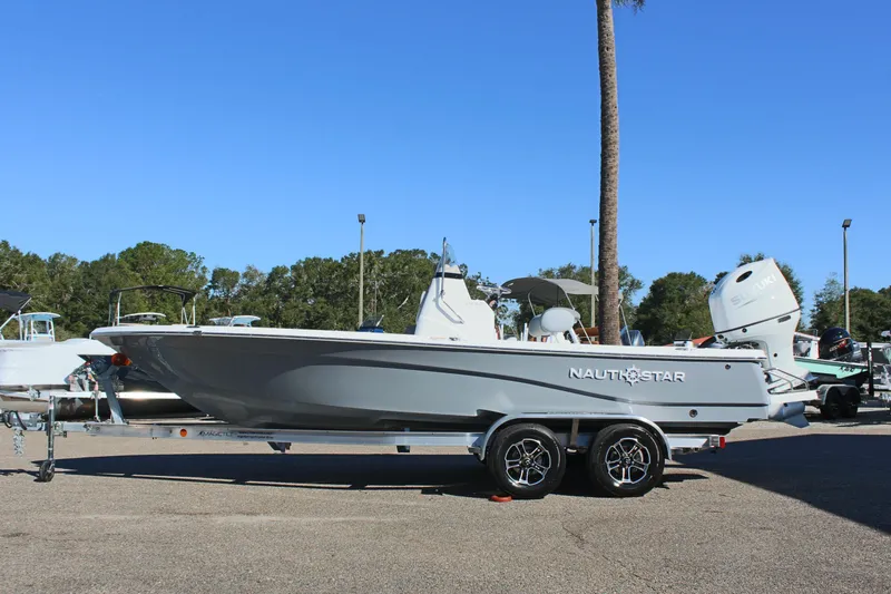 Slide: The Image of 2025 NauticStar 214 Shallow Bay boat on trailer, parked outdoors. - 3