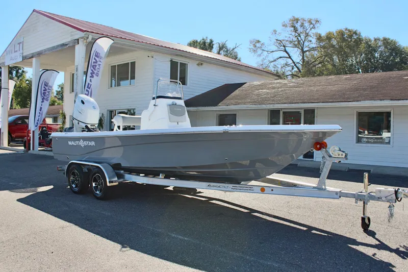 Slide: The Image of 2025 NauticStar 214 Shallow Bay boat on trailer outside dealership. - 5
