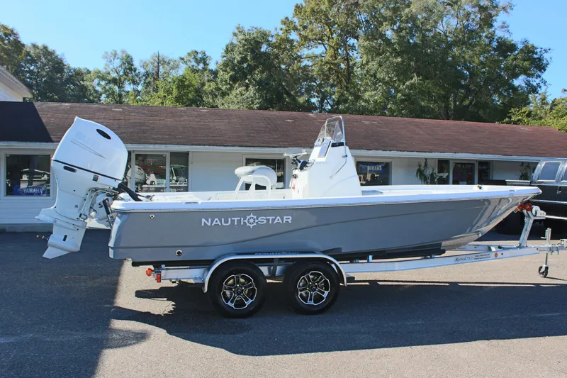 Slide: The Image of 2025 NauticStar 214 Shallow Bay boat on trailer, parked outdoors. - 7