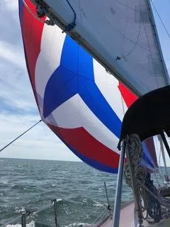 Slide: The Image of Sailing yacht Tartan 31 (1988) with colorful spinnaker on open sea. - 12