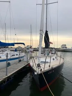 Slide: The Image of 1988 Tartan 31 sailboat docked at marina, overcast sky. - 14
