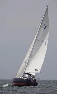 Slide: The Image of Sailing yacht Tartan 31, 1988 model, navigating open waters with full sails. - 15