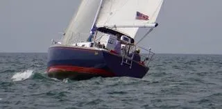 Slide: The Image of Sailing yacht Tartan 31 from 1988 navigating open waters. - 16