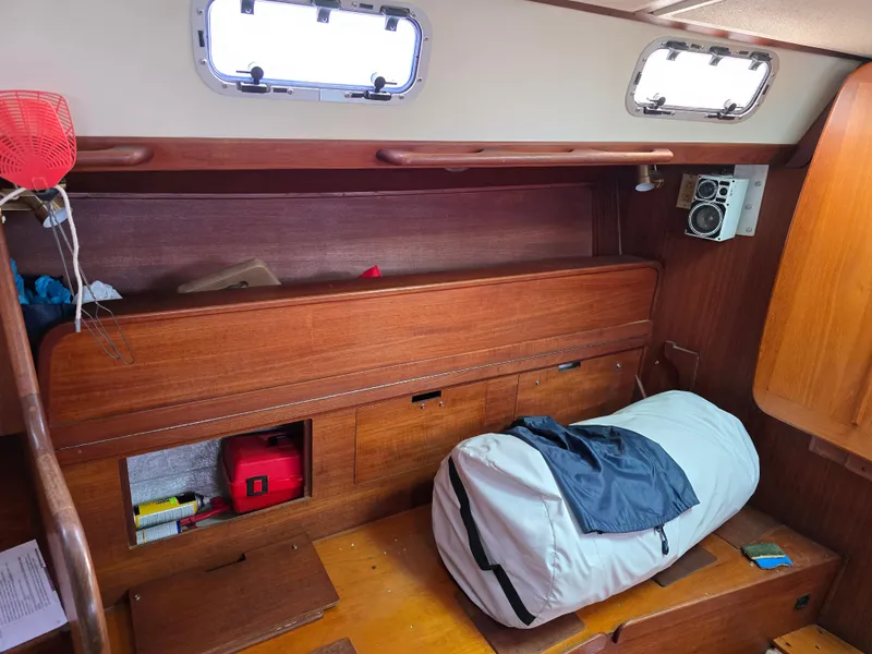 Slide: The Image of Interior of 1988 Tartan 31 sailboat with wooden cabinetry and storage. - 19