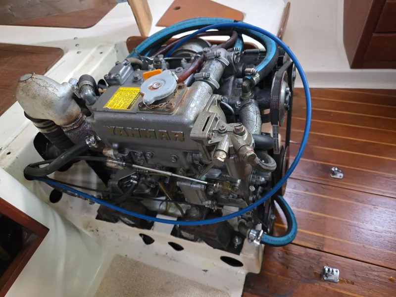 Slide: The Image of Engine of a 1988 Tartan 31 sailboat, featuring detailed mechanical components. - 23