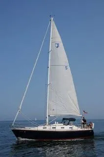 Slide: The Image of 1988 Tartan 31 sailboat on calm sea under clear blue sky. - 7