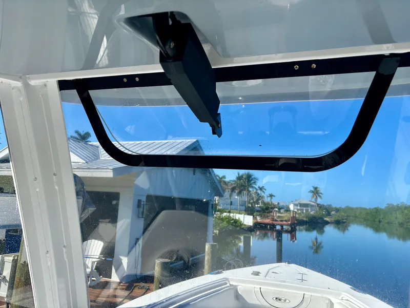 Slide: The Image of 2017 Sea Hunt Gamefish 27 boat window view, overlooking a serene waterfront with palm trees. - 10