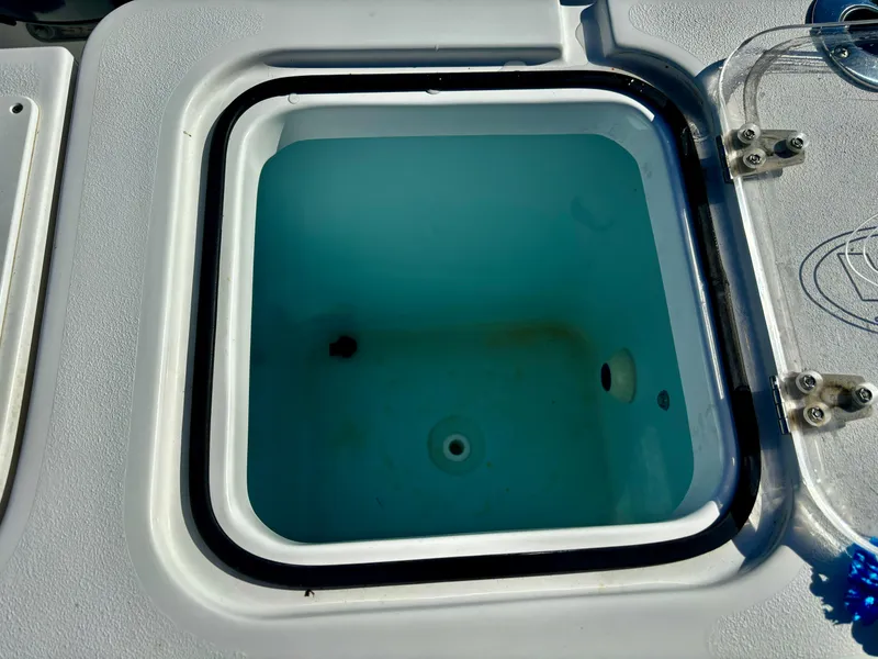 Slide: The Image of Livewell on 2017 Sea Hunt Gamefish 27 boat, open lid, blue interior. - 11