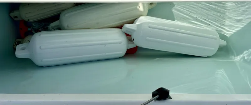 Slide: The Image of White boat fenders inside a storage compartment on a 2017 Sea Hunt Gamefish 27. - 12