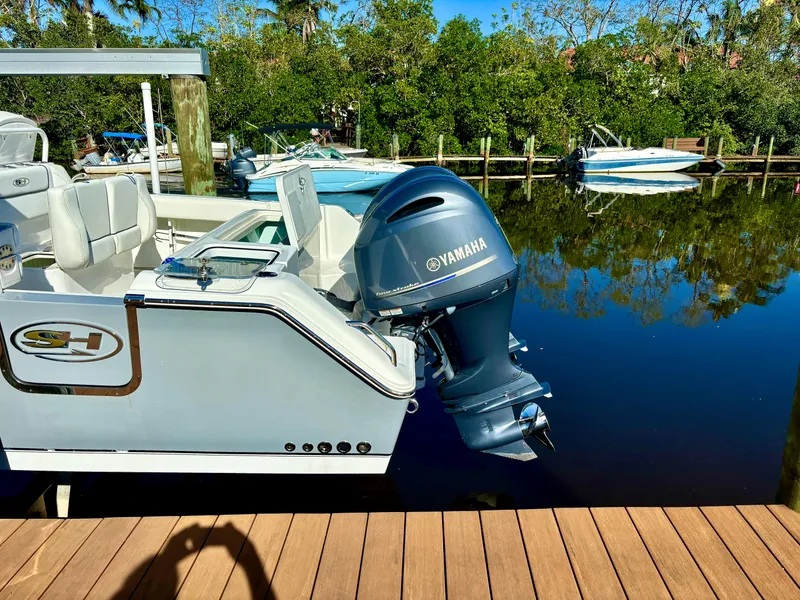 Slide: The Image of 2017 Sea Hunt Gamefish 27 boat with Yamaha outboard motor docked by a wooden pier. - 5