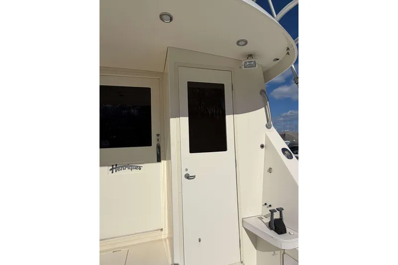 Slide: The Image of 1992 Henriques 50 Sportfisherman boat exterior with door and logo detail. - 10