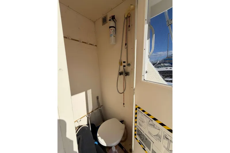 Slide: The Image of Interior of 1992 Henriques 50 Sportfisherman boat bathroom with toilet and shower. - 11