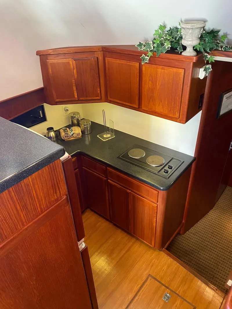 Slide: The Image of 1992 Henriques 50 Sportfisherman kitchen with wooden cabinets and compact stove. - 15