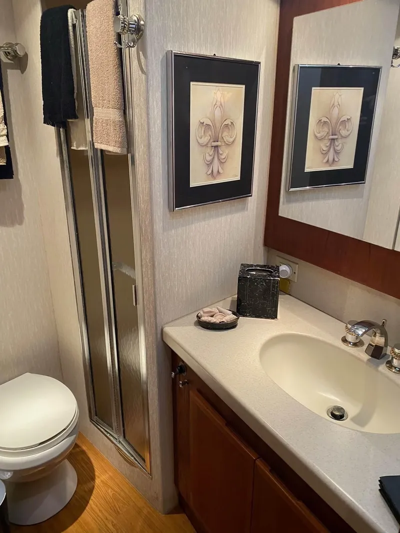 Slide: The Image of 1992 Henriques 50 Sportfisherman bathroom with sink, mirror, and shower. - 21