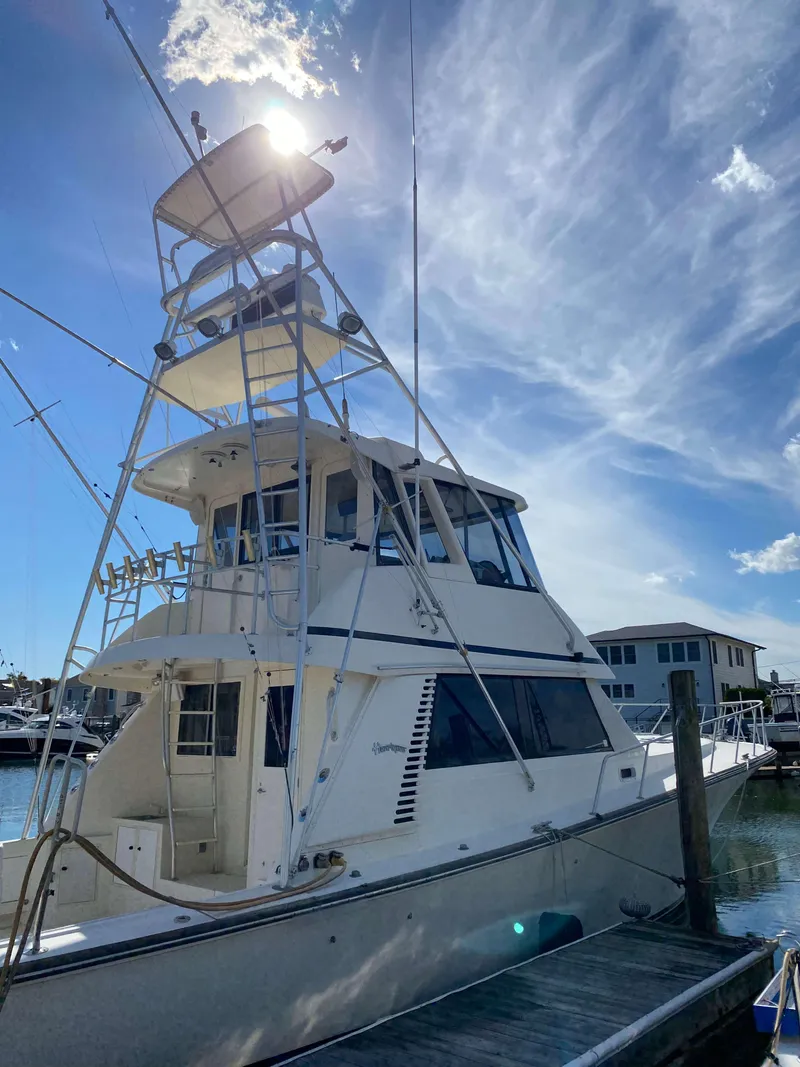 Slide: The Image of 1992 Henriques 50 Sportfisherman docked under a bright blue sky. - 3