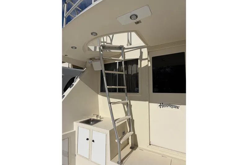 Slide: The Image of 1992 Henriques 50 Sportfisherman boat interior with ladder and sink area. - 34