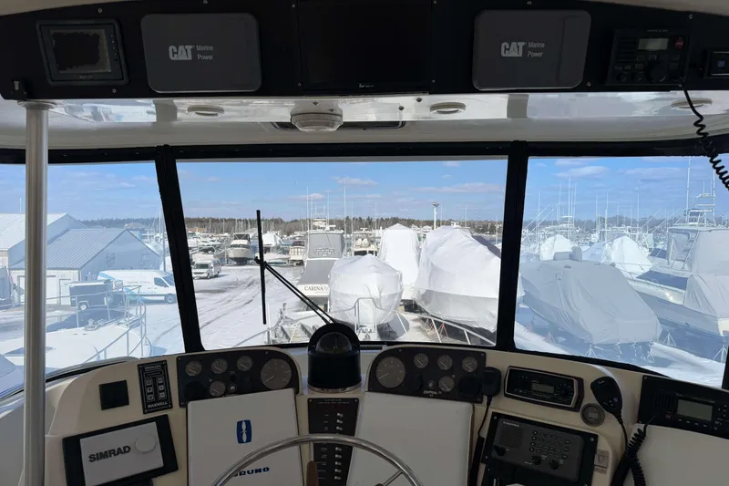 Slide: The Image of Interior view of 1992 Henriques 50 Sportfisherman boat cockpit with marina in background. - 38