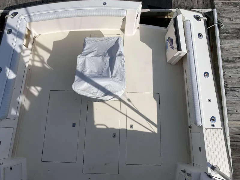 Slide: The Image of Henriques 50 Sportfisherman 1992 boat deck with seating and covered chair. - 4