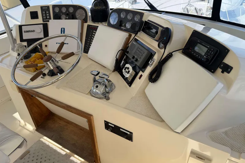 Slide: The Image of 1992 Henriques 50 Sportfisherman helm with steering wheel, navigation instruments, and communication devices. - 41