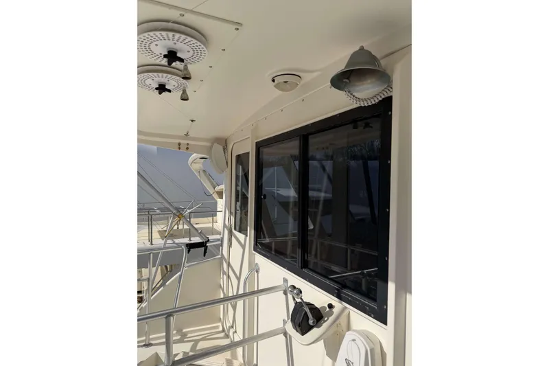 Slide: The Image of 1992 Henriques 50 Sportfisherman boat deck with windows and railing. - 43