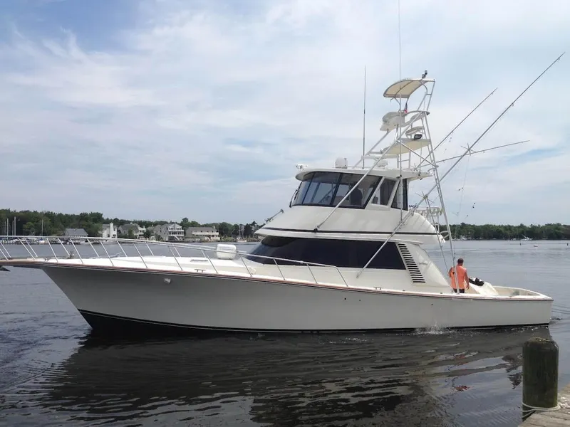 Slide: The Image of 1992 Henriques 50 Sportfisherman yacht on calm water, side view. - 44