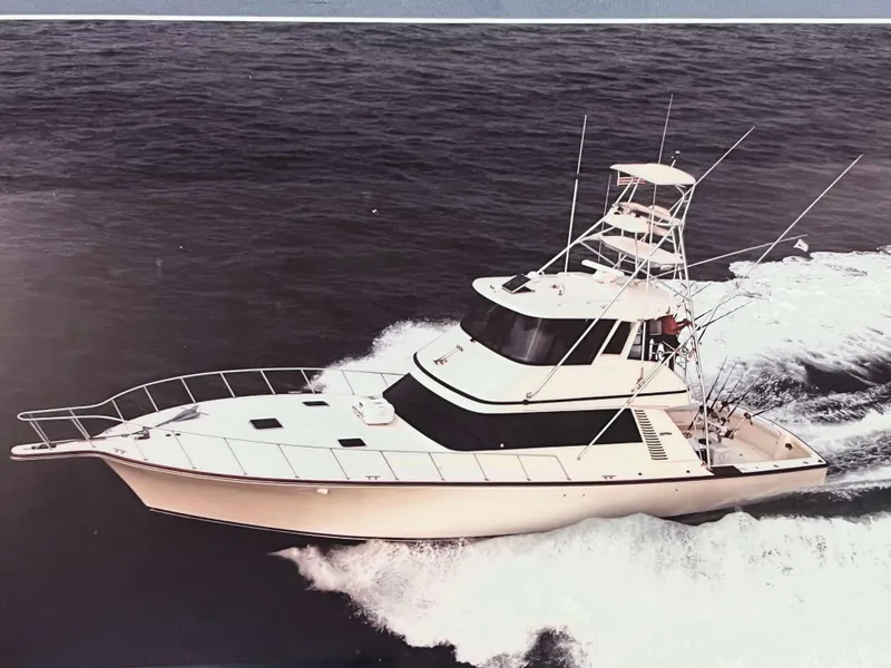 Slide: The Image of 1992 Henriques 50 Sportfisherman cruising on open sea, showcasing sleek design and powerful performance. - 46