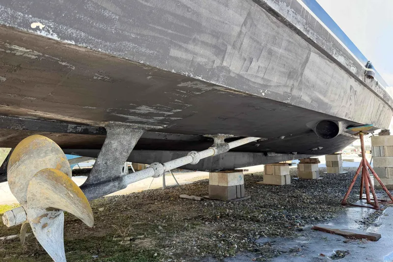 Slide: The Image of 1992 Henriques 50 Sportfisherman boat under maintenance, showing propeller and hull on blocks. - 48