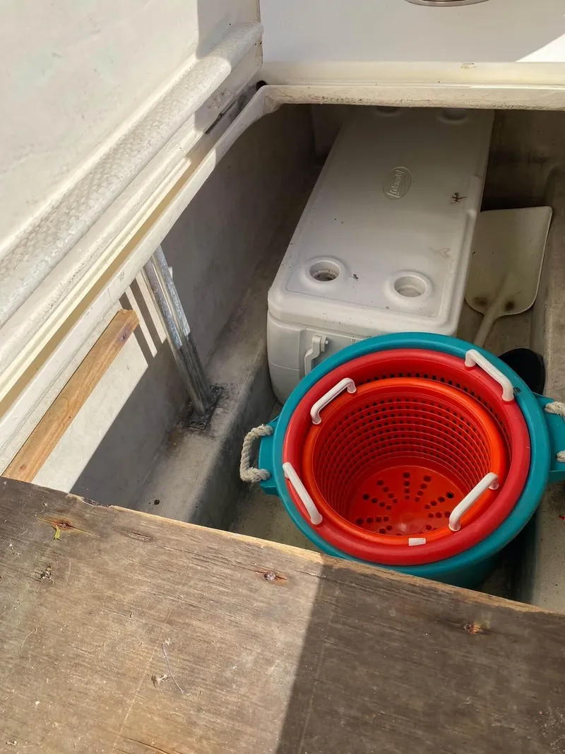 Slide: The Image of Storage compartment on 1992 Henriques 50 Sportfisherman with cooler and colorful basket. - 8