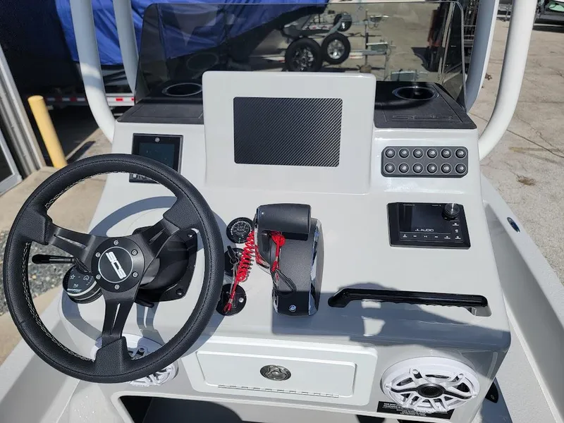 Slide: The Image of 2025 SCB R24 boat console with steering wheel, controls, and display panel. - 11