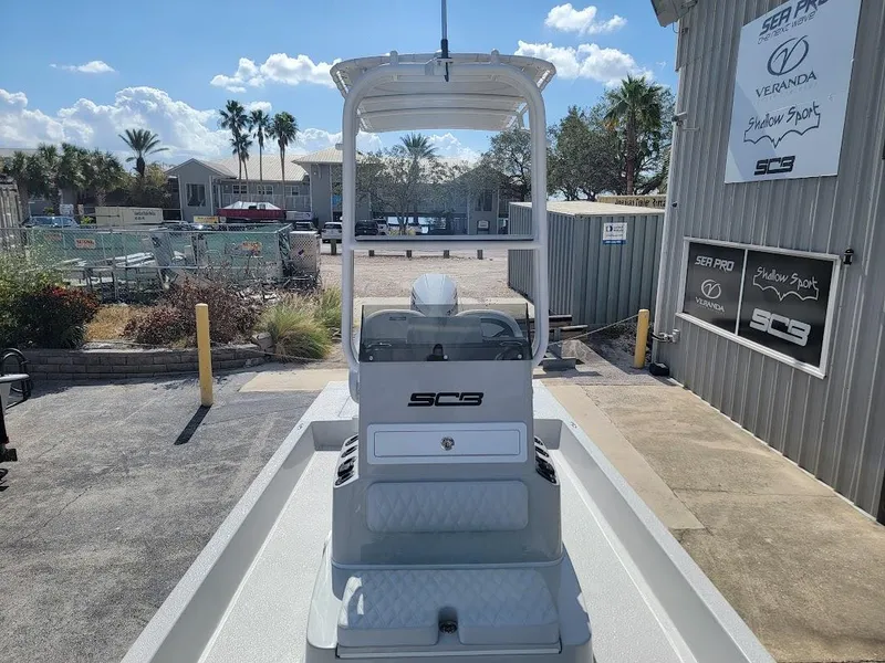 Slide: The Image of 2025 SCB R24 boat at marina, sunny day, palm trees in background. - 13