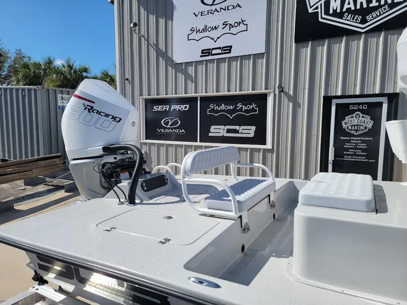 Slide: The Image of 2025 SCB R24 boat with racing engine, displayed outdoors near marine sales signage. - 7