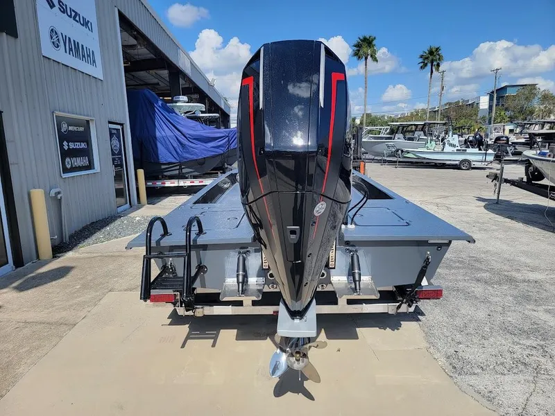 Slide: The Image of 2025 SCB S22 boat with powerful outboard motor at a dealership. - 11