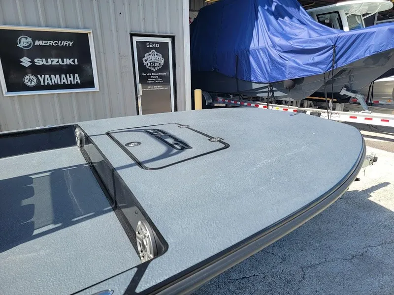 Slide: The Image of 2025 SCB S22 boat deck near marine service center with Yamaha, Suzuki, Mercury signage. - 6