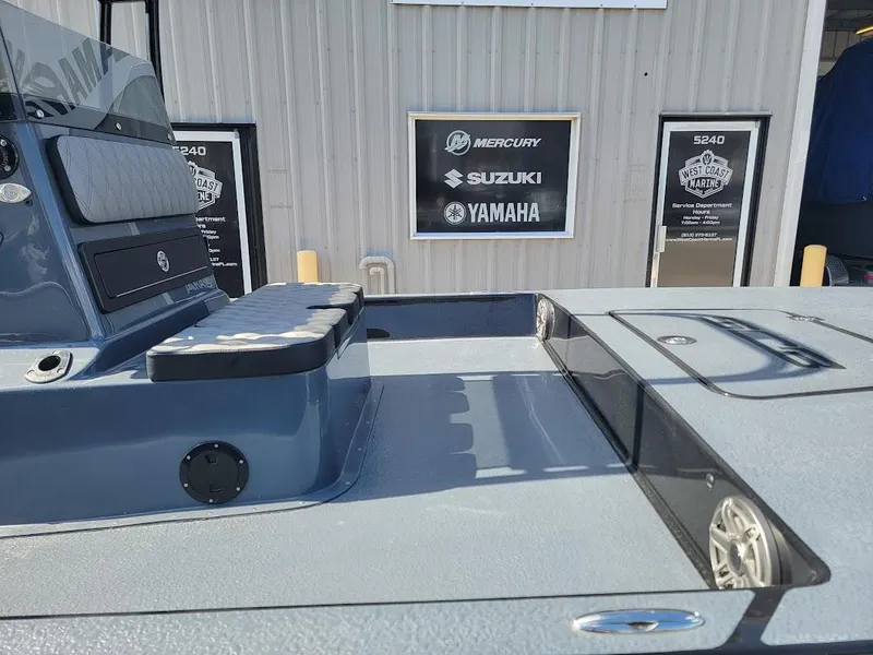 Slide: The Image of 2025 SCB S22 boat interior with seating and storage, displayed outside dealership. - 7