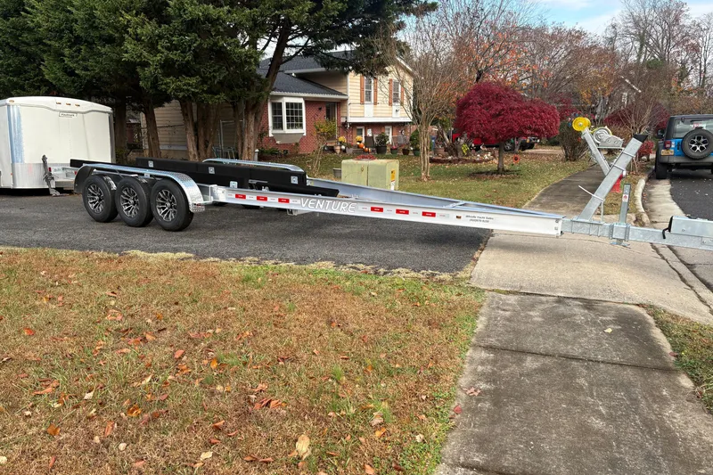 Slide: The Image of Boat trailer parked on suburban street, suitable for 2000 Sport-Craft 272 Sportfish. - 12