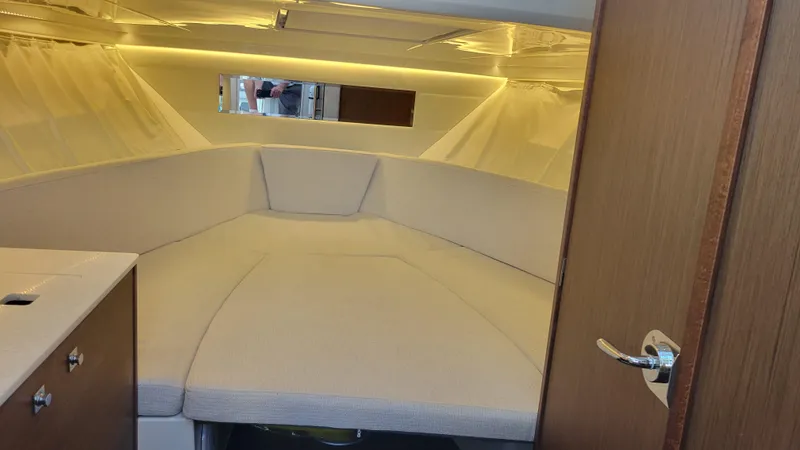 Slide: The Image of Interior cabin of 2023 Jeanneau LEADER 9.0WA with cozy seating and ambient lighting. - 11
