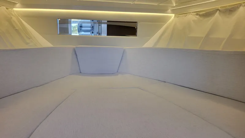 Slide: The Image of Interior cabin of 2023 Jeanneau LEADER 9.0WA boat, featuring modern design and soft lighting. - 12